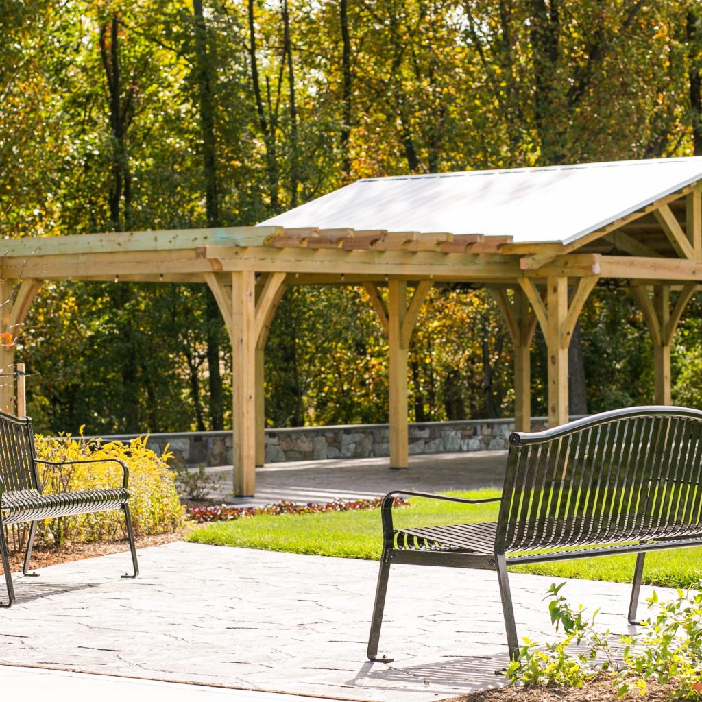 Park seating beside an open post and beam Waynesville NC pavilion